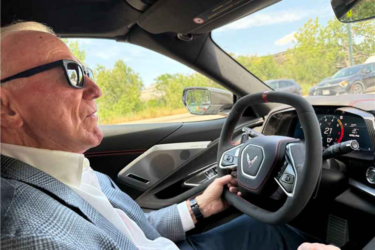 Larry Mizel driving Corvette